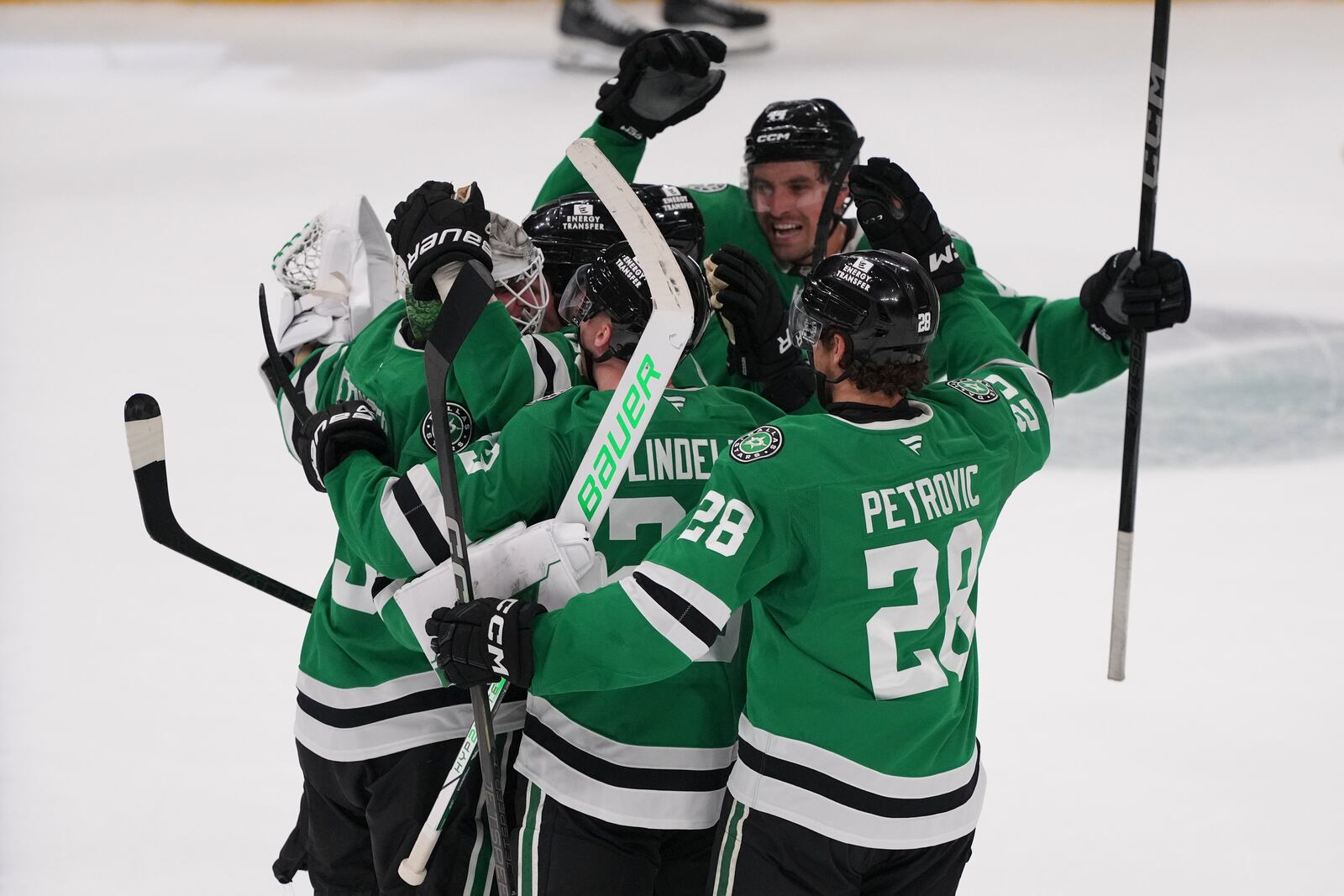 Dallas Stars players celebrate a game-winning goal by Colin Blackwell, not pictured, during overtime in Game 2 of a first-round NHL hockey playoff series against the Colorado Avalanche early Tuesday, April 22, 2025, in Dallas. (AP Photo/Julio Cortez)