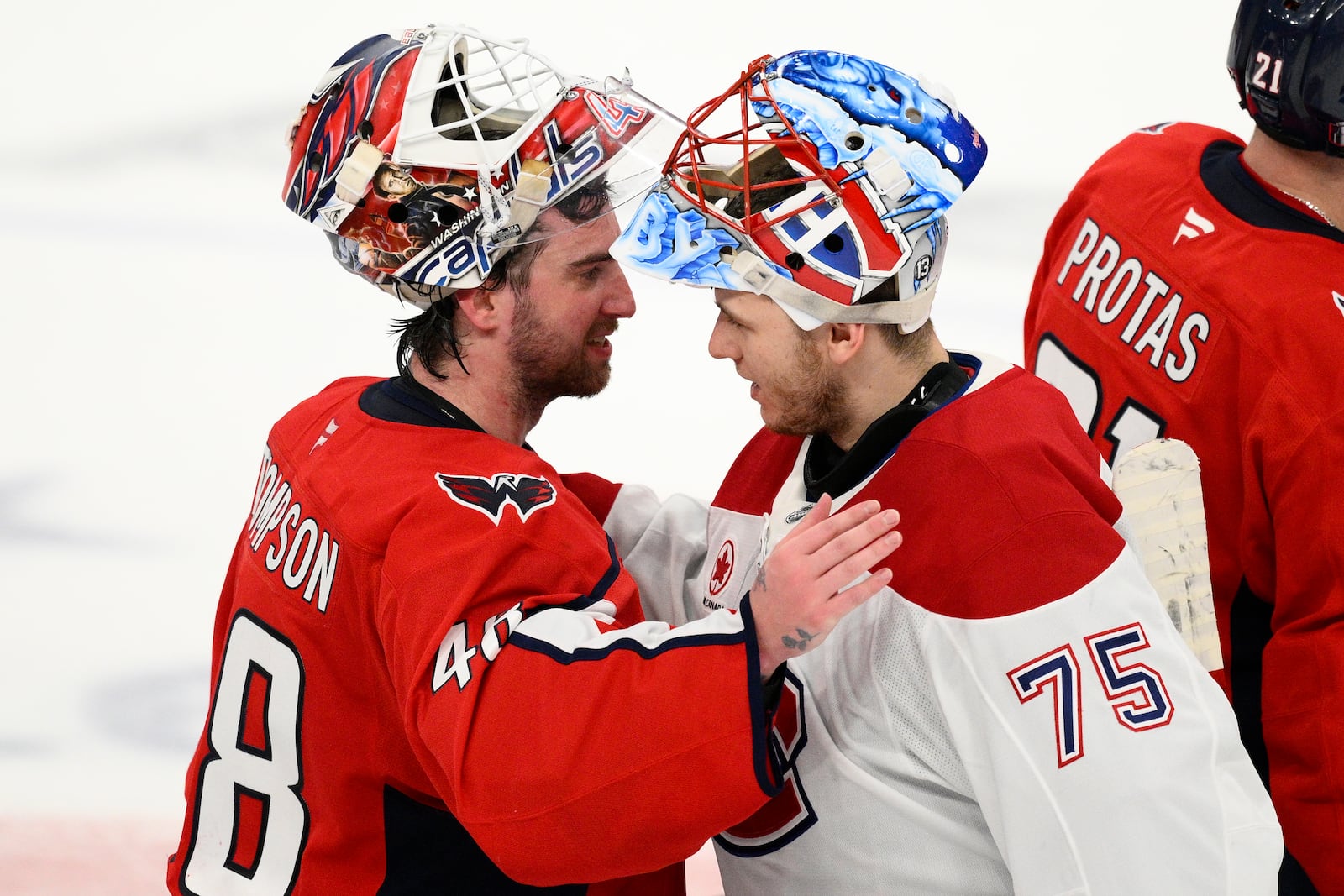 Washington Capitals goaltender Logan Thompson (48) greets Montreal Canadiens goaltender Jakub Dobes (75) after Game 5 of a first-round NHL hockey playoff series Wednesday, April 30, 2025, in Washington. (AP Photo/Nick Wass)