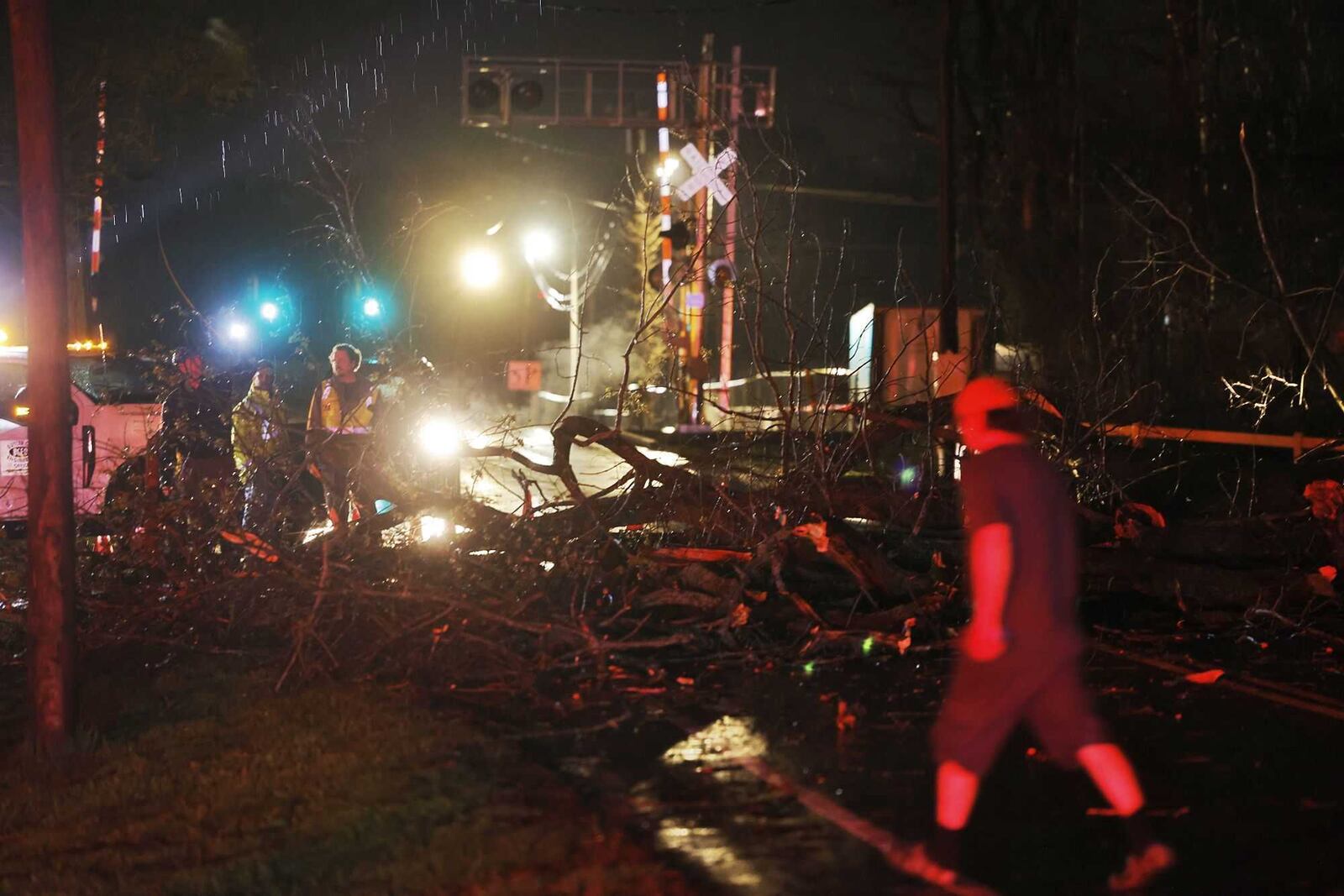 First responders arrive at Trenton Road in St. Clair Township on Sunday night, March 30, 2025, where a tree was down over the road after strong thunderstorms. Crews were checking for possible damage to trailers in a mobile home community there. NICK GRAHAM / STAFF