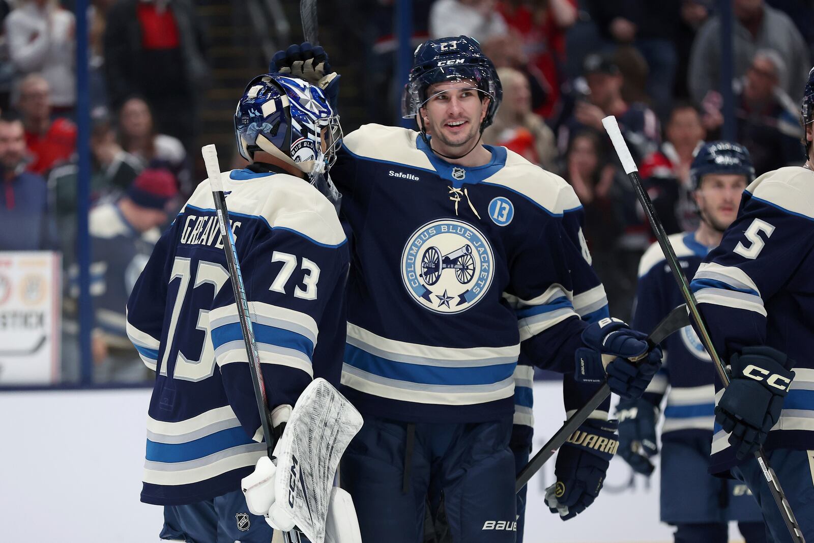 Columbus Blue Jackets goaltender Jet Greaves (73) celebrates with center Sean Monahan (23) following \ an NHL hockey game against the Washington Capitals on Saturday, April 12, 2025, in Columbus, Ohio. (AP Photo/Joe Maiorana)
