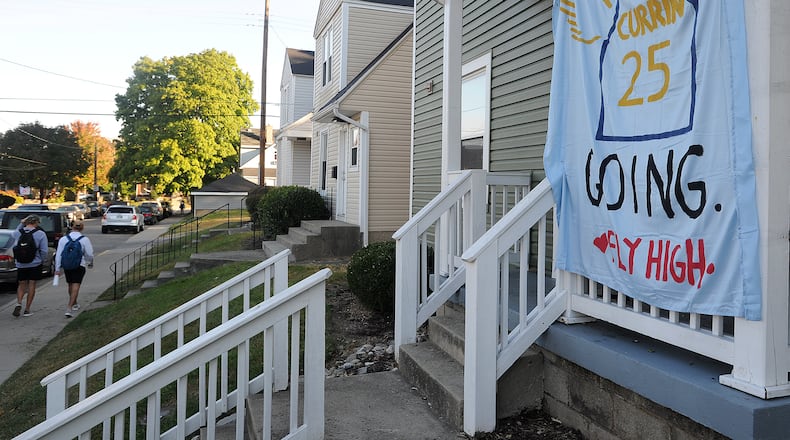 Many houses on the University of Dayton campus display decorated sheets as a tribute to student Michael Currin, who dies Sept. 21. Police say he fell from the bed of a pickup truck and died several days later from his injuries. MARSHALL GORBY/STAFF