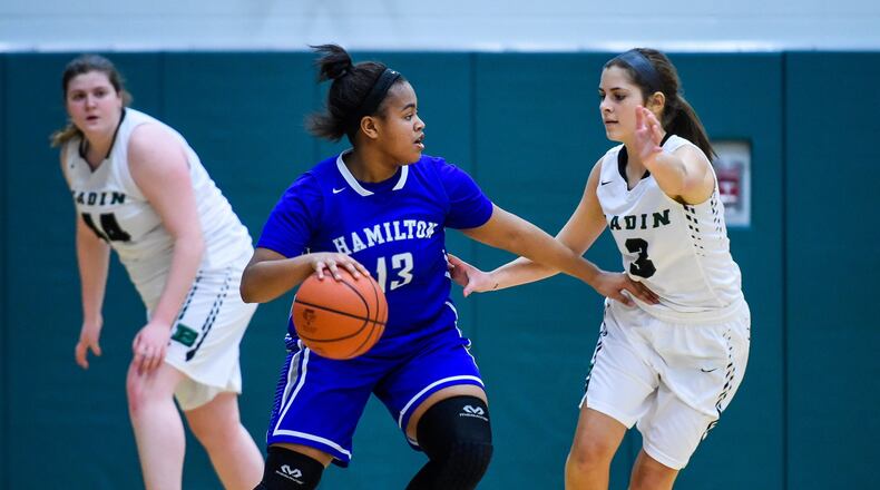 Hamilton’s Kira Ash dribbles the ball while being defended by Badin’s Ally Stang during their game Monday night at Mulcahey Gym in Hamilton. NICK GRAHAM/STAFF