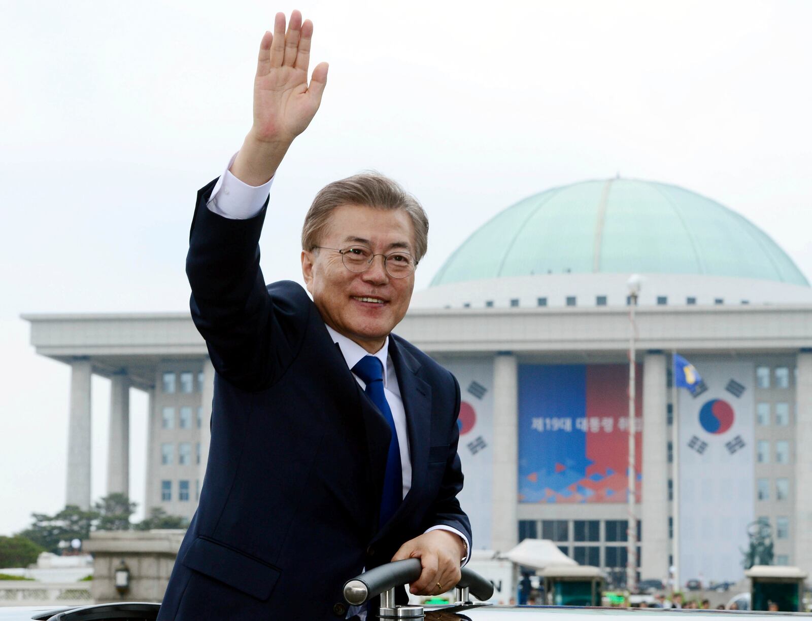 FILE - South Korea's new President Moon Jae-in waves from a car after his inauguration ceremony outside of the National Assembly in Seoul, South Korea, on May 10, 2017. (Hong Hae-in/Yonhap via AP, File)