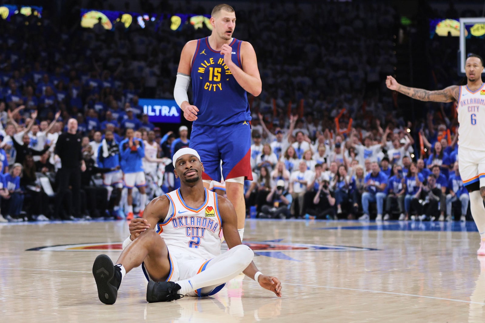 Oklahoma City Thunder's Shai Gilgeous-Alexander (2) sits on th court after a play against Denver Nuggets' Nikola Jokic (15) in the second half of Game 5 of an NBA basketball second-round playoff series Tuesday, May 13, 2025, in Oklahoma City. (AP Photo/Nate Billings)