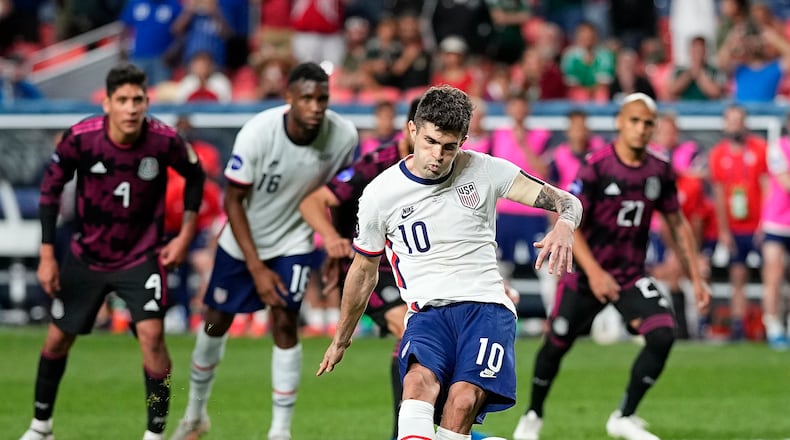 United States' Christian Pulisic (10) kicks a penalty kick for a goal against Mexico during extra time in the CONCACAF Nations League championship soccer match, Sunday, June 6, 2021, in Denver. (AP Photo/Jack Dempsey)