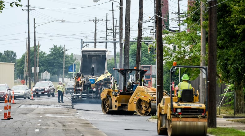 Paving crews will be busy for the next 10 years in Hamilton and for the next two years in Middletown as both cities received voter approved tax increases for street repairs and resurfacing in 2021. FILE PHOTO