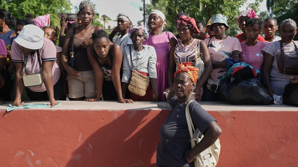 Residents attend the funeral of people killed in a landslide triggered by Hurricane Melissa in Petit-Goave, Haiti, Saturday, Nov. 15, 2025. (AP Photo/Odelyn Joseph).