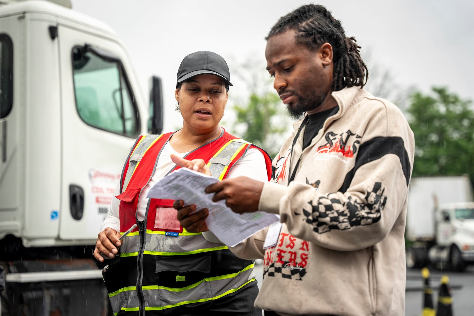 An instructor helps a student study at the Driving Academy on Tuesday, June 10, 2025 in Linden, N.J. where students prepare to obtain a Commercial Driver’s License (CDL) with multilingual instructors. (AP Photo/Angelina Katsanis)