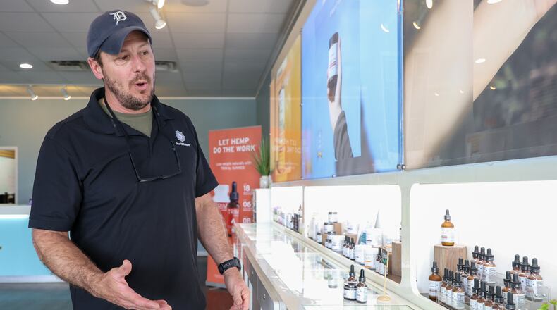 Rob McClure, the owner of Your CBD Store, talks about products at the store's Centerville location on Wilmington Pike on Wednesday. McClure said if Senate Bill 86 passes, he'll no longer be able to sell his "bread and butter," tinctures of full-spectrum CBD oil. The bill, which passed 33-0 this week, targets any product with more than two milligrams of delta-9 THC or more than 0.5 milligrams of any other "non-delta-9 THC," per package. BRYANT BILLING / STAFF