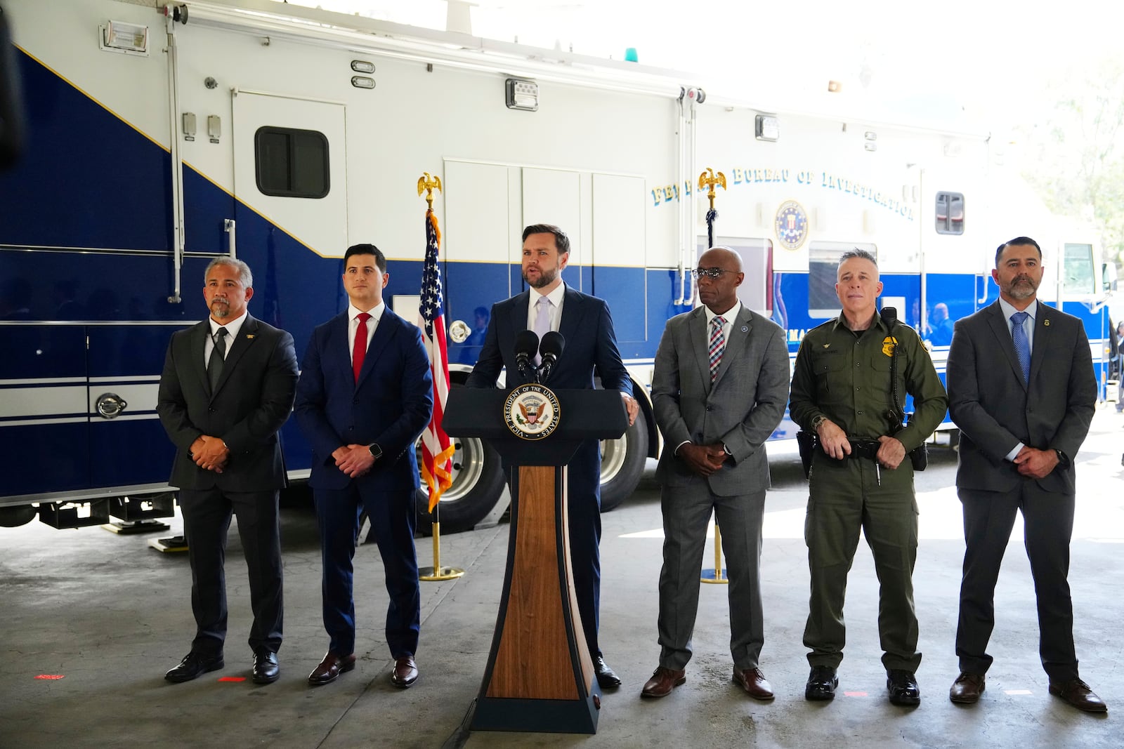 Vice President JD Vance, center, speaks next to officials including, from left to right, HUD Regional Administrator William Spencer, United States Attorney for the Central District of California Bill Essayli, FBI Los Angeles Assistant Director Akil Davis, US Border Patrol Sector Chief Gregory Bovino and ICE Field Office Director Ernie Santacruz at the Wilshire Federal Building Friday, June 20, 2025, in Los Angeles. (AP Photo/Jae C. Hong)