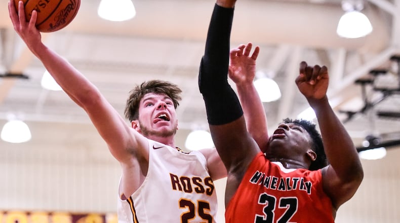 Cole Gronas from Ross puts up a shot defended by Mount Healthy’s Brandon Lanier during Tuesday night’s game at Ross. Mount Healthy won 65-46. NICK GRAHAM/STAFF