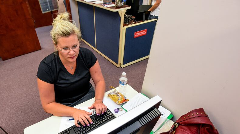 Angie Hill fills out applications and searches for jobs in the resource room at Ohio Means Jobs Wednesday, June 14 in Fairfield. Butler County Job and Family Services is planning to makes some changes in the way they deliver public assistance, including job training programs like the ones offered at Ohio Means Jobs. NICK GRAHAM/STAFF