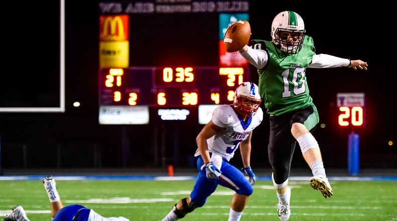 Badin quarterback Zach Switzer jumps out of bounds for a first down during their homecoming football game against Carroll Friday, Sept. 28 at Hamilton High School’s Virgil M. Schwarm Stadium. The Rams won 24-21. NICK GRAHAM/STAFF