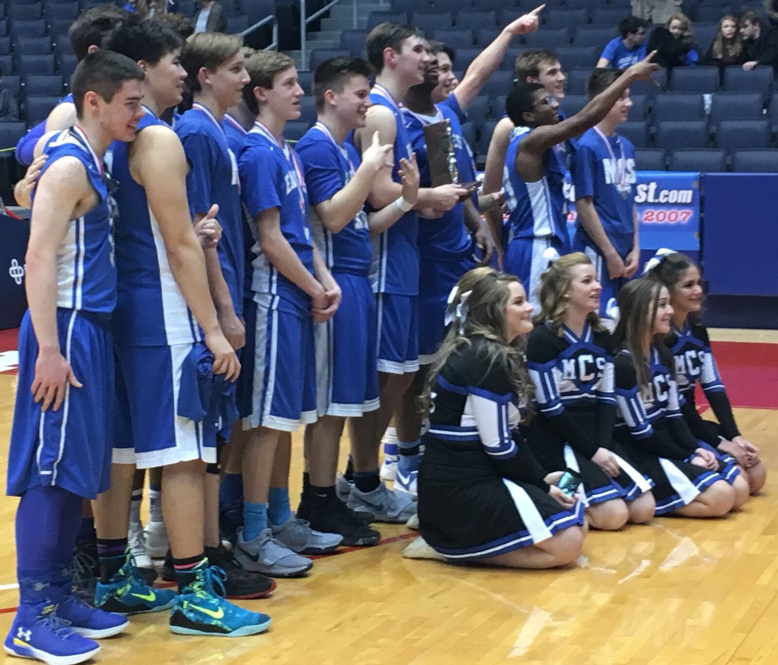 Middletown Christian’s players and cheerleaders face their fans after losing to Fort Loramie in Friday night’s Division IV district final at the University of Dayton Arena. RICK CASSANO/STAFF