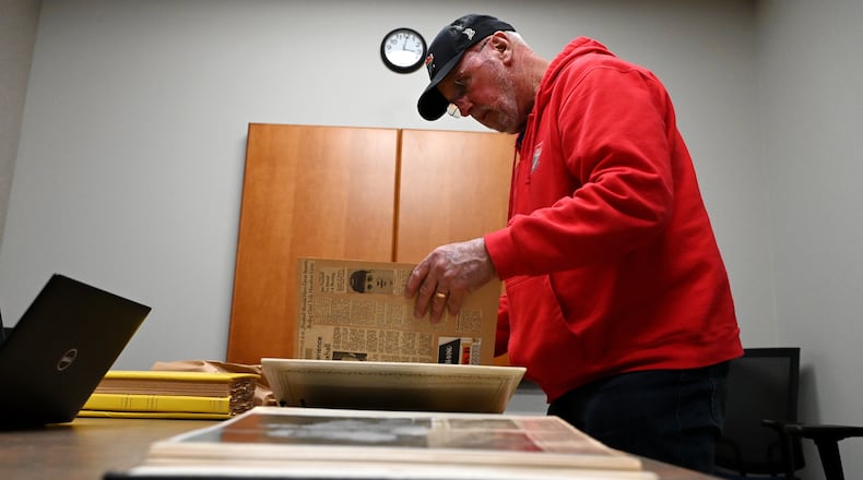 The Nuxhall family is working with the Lane Libraries and Miami University to archive more than 50 scrap books, mostly of the late Joe Nuxhall's baseball career. More than 30 have already been digitized, which will eventually be made available on the Lane Library's website. The most of the physical copies will be displayed at the Nuxhall Foundation's Hope Center, a year-round indoor facility for special needs athletes. Pictured is Kim Nuxhall, chairman of the Nuxhall Foundation board of directors, and youngest son of Joe Nuxhall. MICHAEL D. PITMAN/STAFF