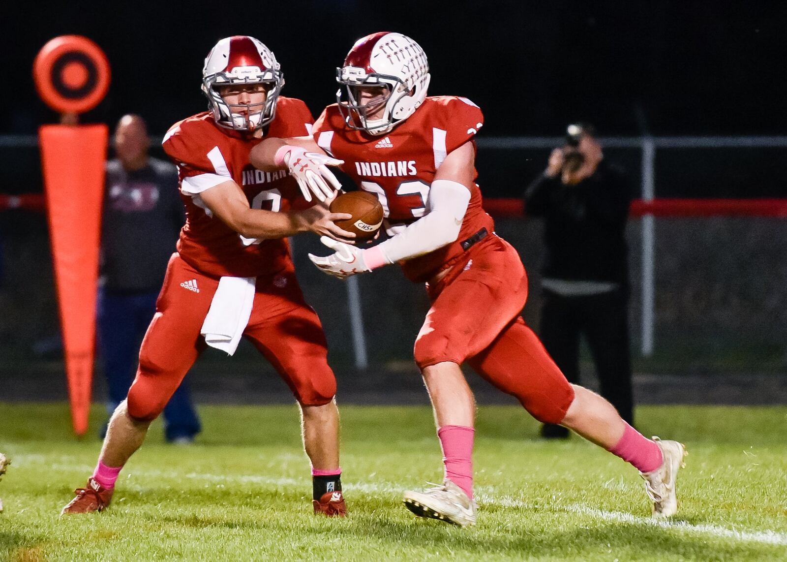Carlisle quarterback Jake Moore hands off to Spencer Mays during Thursday night’s game against Eaton at Laughlin Field in Carlisle. NICK GRAHAM/STAFF