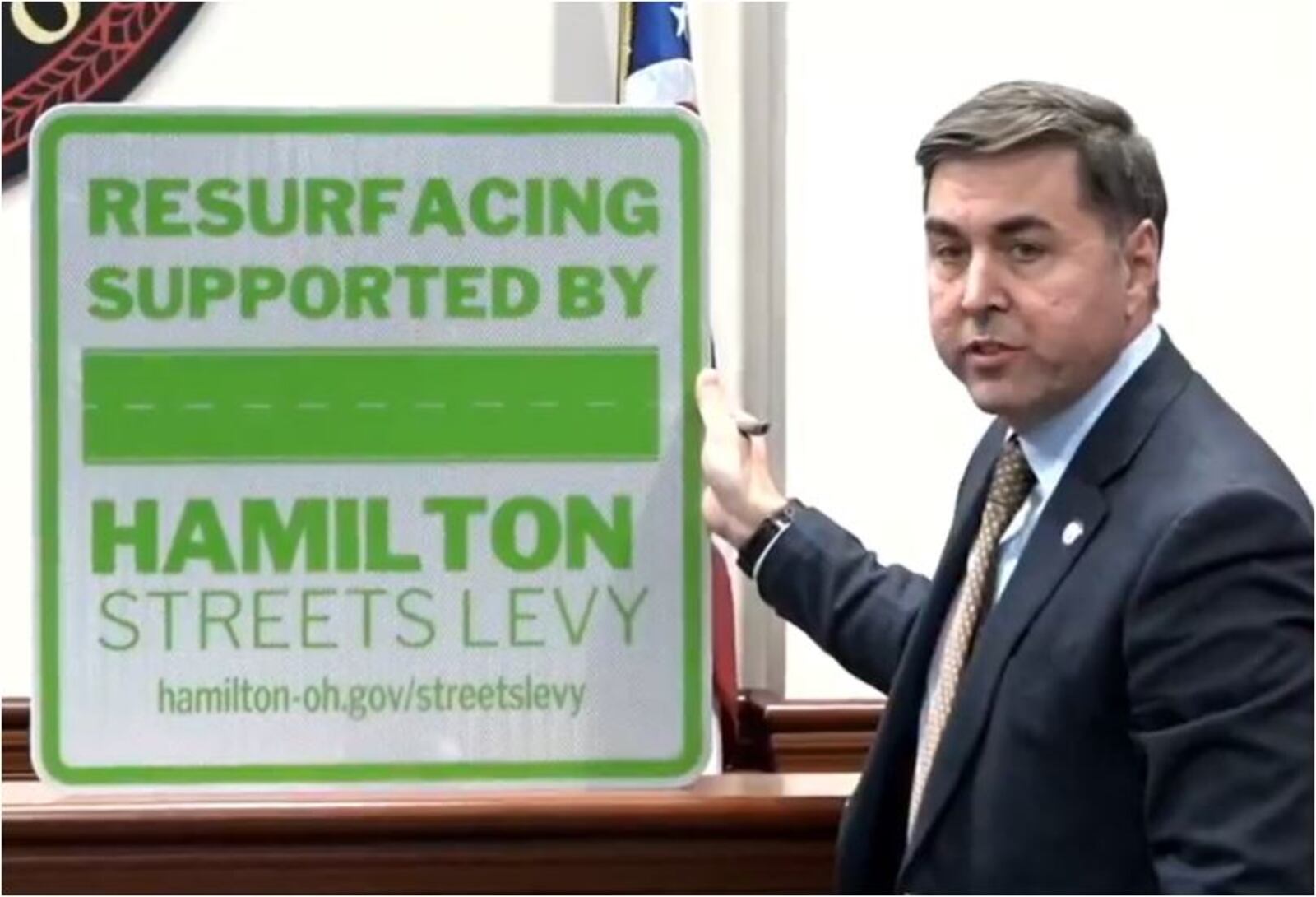 As a way to let Hamilton residents know which streets were paved using street-repair-levy funds, Hamilton has created signs for those areas. City Manager Joshua Smith showed one off recently at a City Council meeting. MIKE RUTLEDGE/STAFF