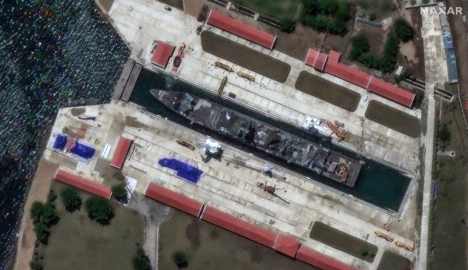 This satellite image provided by Maxar Technologies shows a North Korea's new naval destroyer, initially damaged in a failed launch ceremony at the Chongjin port on May 22, shortly after the ship arrived for a ceremonial relaunch at the Rajin dockyard in Najin, North Korea, Sunday, June 8, 2025. (Maxar Technologies via AP)