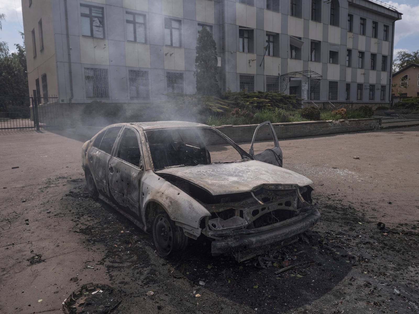 In this photo provided by Ukraine's 93rd Kholodnyi Yar Separate Mechanized Brigade press service, a burnt car with a charred body of a 55-year-old driver inside is seen following the strike of Russian Molniya-1 drone in the center of Kostyantynivka, Donetsk region, Ukraine, Friday, May 16, 2025. (Iryna Rybakova/Ukraine's 93rd Mechanized Brigade via AP)