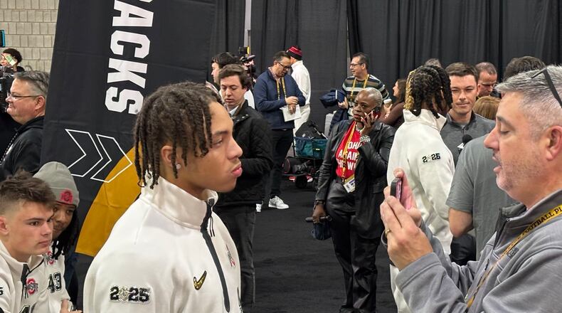 Ohio State CB Aaron Scott Jr. speaks to reporter Dave Biddle at the 2025 College Football Playoff National Championship Game Media Day in Atlanta, Ga.