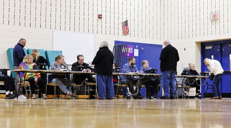 Poll workers check in voters on election day Tuesday, March 19, 2024 at Creekview Elementary School in Middletown. NICK GRAHAM/STAFF
