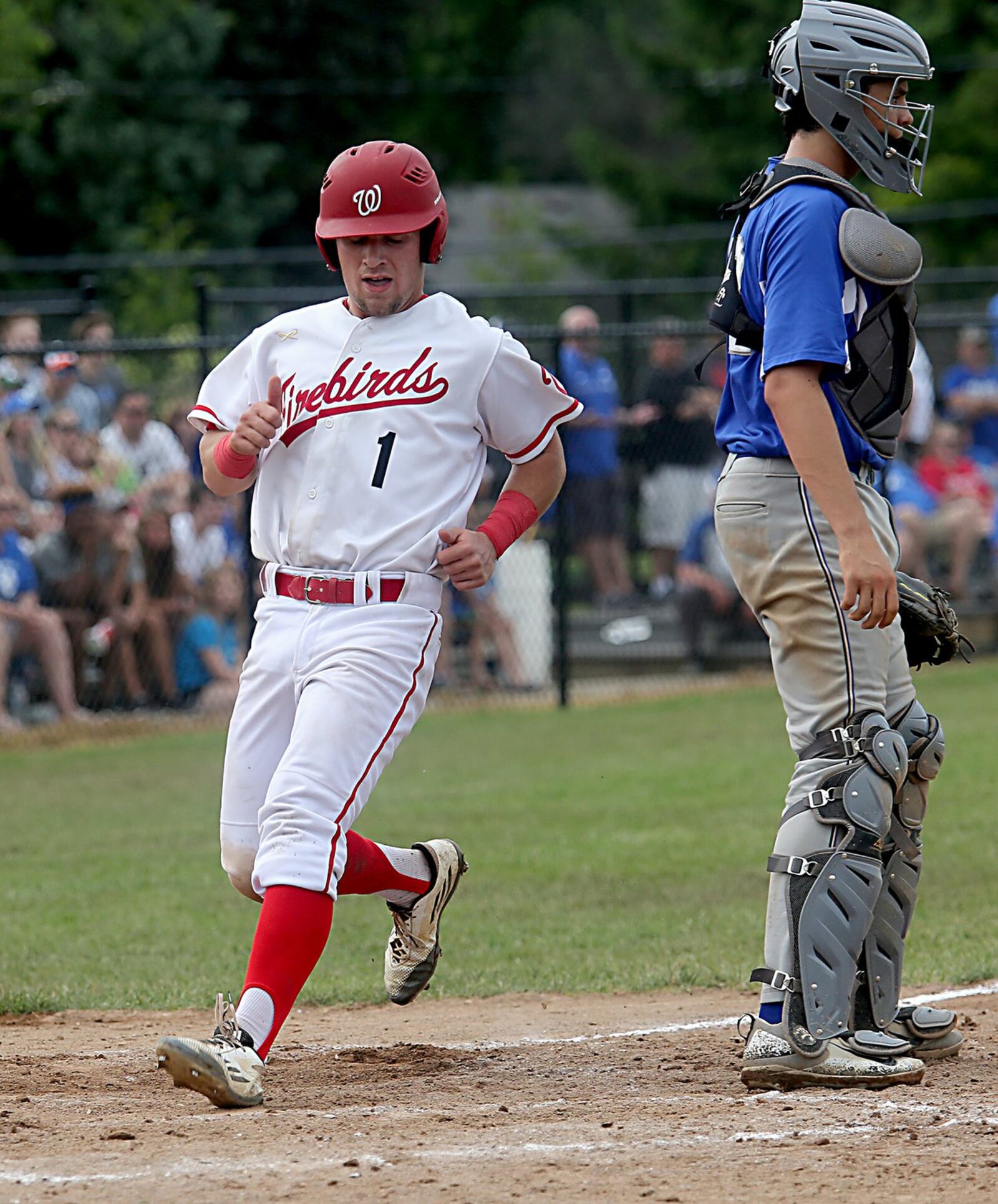 Brennen Martin scores Lakota West’s first run as Springboro catcher Jacob Beachy waits for a throw Saturday during a Division I district final at Centerville. CONTRIBUTED PHOTO BY E.L. HUBBARD