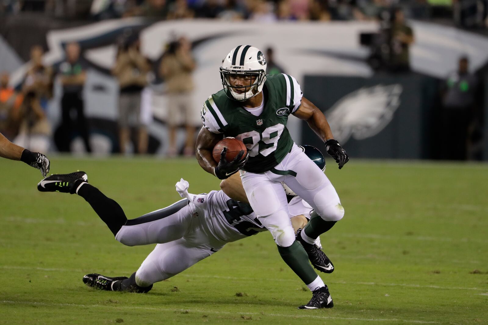 Jalin Marshall, of the New York Jets, runs with the ball against the Eagles’ Chris Maragos during the first half of a preseason game, Thursday, Sept. 1, 2016, in Philadelphia. (AP Photo/Matt Rourke)