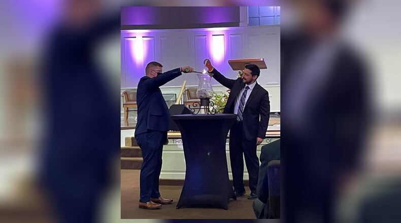 Officials from Middletown Christian School recently celebrated with a mortgage burning ceremony in the school's partner Grace Baptist Church. The pre-K through 12 school is one of the largest, non-Catholic private schools in the region. Pictured left is Superintendent Brian Williams joined by Pastor Max Fernandez. (Provided Photo\Journal-News)