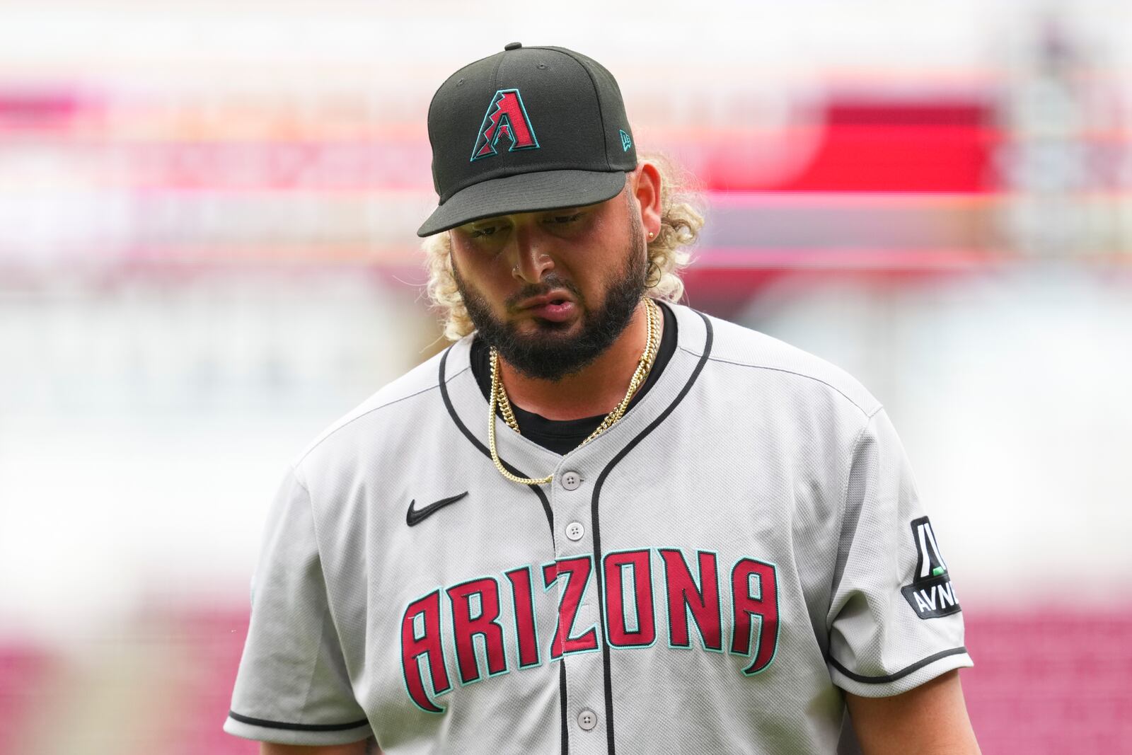Arizona Diamondbacks pitcher Juan Morillo walks to the dugout during the seventh inning of a baseball game against the Cincinnati Reds that was suspended Friday because of rain and resumed, Saturday, June 7, 2025, in Cincinnati. (AP Photo/Jeff Dean)