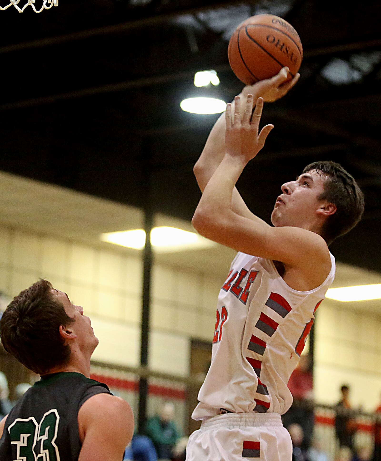 Carlisle forward Justin Flor sinks a shot over Badin center Brian Gerbus during Saturday night’s game at The Pit in Carlisle. CONTRIBUTED PHOTO BY E.L. HUBBARD