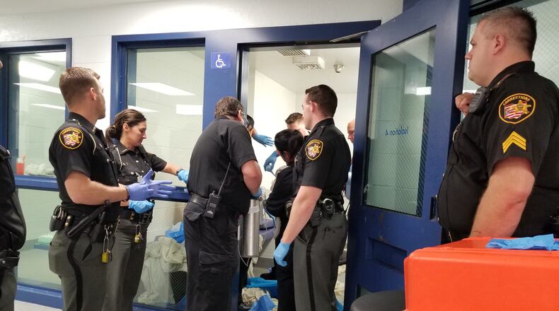 Corrections officers at the Butler County Jail stand-by as another officer and the jail medic helps to deliver a baby girl. The mother is an inmate at the jail. CONTRIBUTED PHOTO/BUTLER COUNTY SHERIFF’S OFFICE
