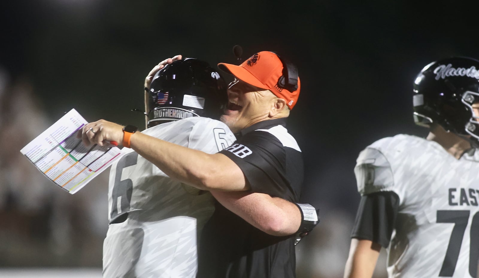 Lakota East coach Jon Kitna celebrates with Dawson Reip after a victory against Centerville on Friday, Aug. 22, 2025, at Centerville Stadium. David Jablonski/Staff