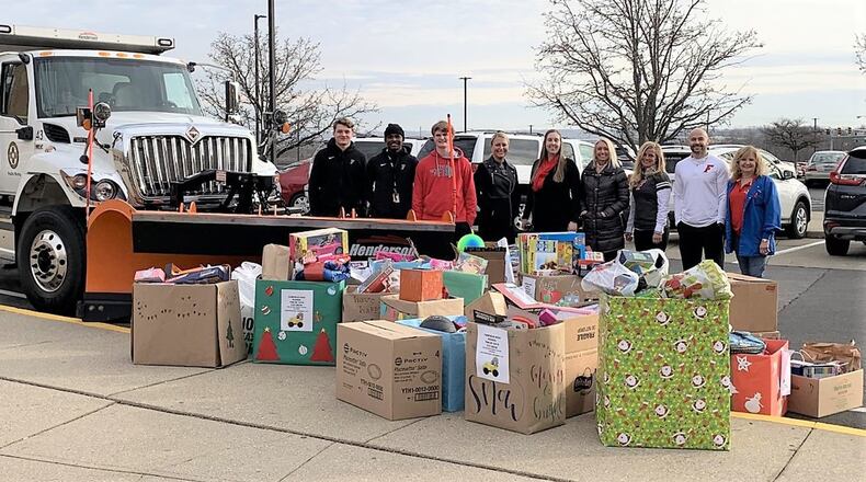 Some of the toys and a few of the hundreds of volunteers pose outside of Fairfield High School for this year’s “Ton of Toys” Christmas drive to make sure area foster children have a toy on that special day. Fairfield Schools’ toy drive for needy Butler County kids saw it collect more than 2,000 donated toys, blowing away last year s total of 1,300 toys, officials said. (Provided Photo/Journal-News)