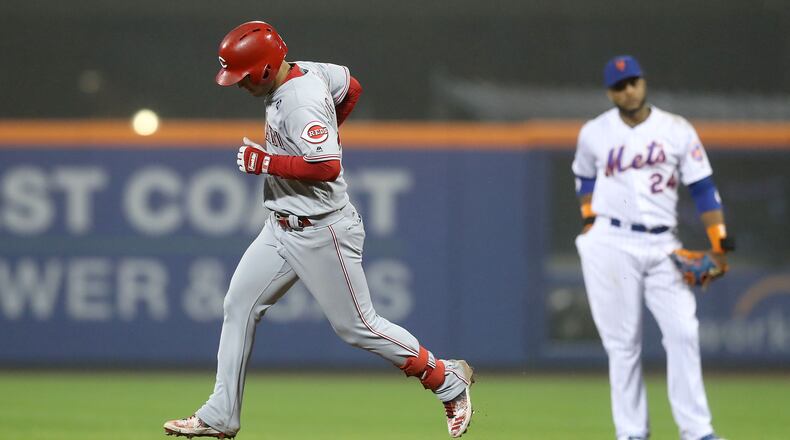 NEW YORK, NEW YORK - MAY 01: Jose Iglesias #4 of the Cincinnati Reds rounds second base after he hit a solo home run in the ninth inning as Robinson Cano #24 of the New York Mets stands by at Citi Field on May 01, 2019 in the Flushing neighborhood of the Queens borough of New York City.The Cincinnati Reds defeated the New York Mets 1-0. (Photo by Elsa/Getty Images)