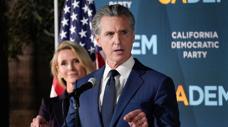California Gov. Gavin Newsom speaks as he stands with first partner Jennifer Siebel Newsom during an election night press conference at a California Democratic Party office Tuesday, Nov. 4, 2025, in Sacramento, Calif. (AP Photo/Godofredo A. Vásquez)