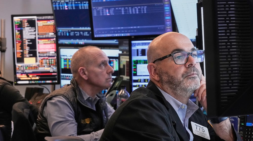 Traders Michael Urkonis, left, and Fred Demarco work on the floor of the New York Stock Exchange, Tuesday, Dec. 2, 2025. (AP Photo/Richard Drew)