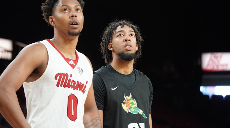 Wright State's Logan Woods (21) and Miami's Eian Elmer (0) watch a free throw during a game at Millett Hall earlier this season. Chris Vogt/CONTRIBUTED