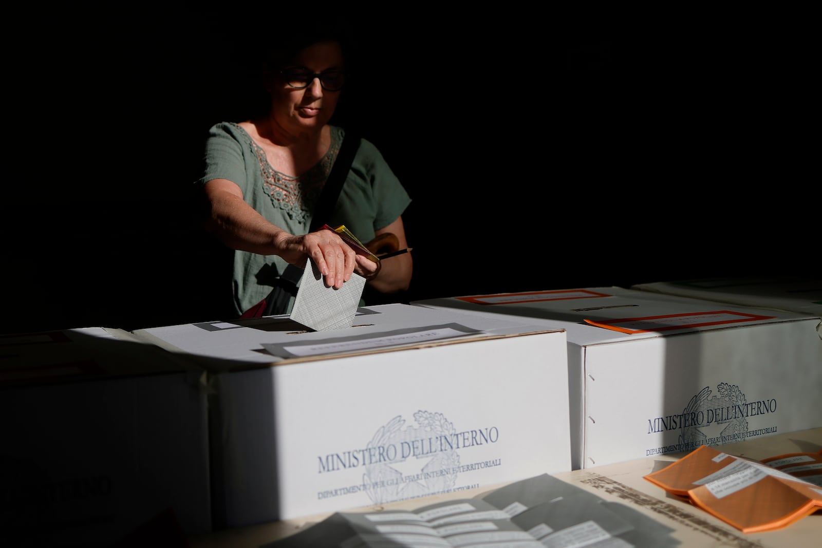 A woman casts her ballots on referendums on citizenship and job protections, at a polling station in Rome, Sunday, June 8, 2025. (Cecilia Fabiano/LaPresse via AP)