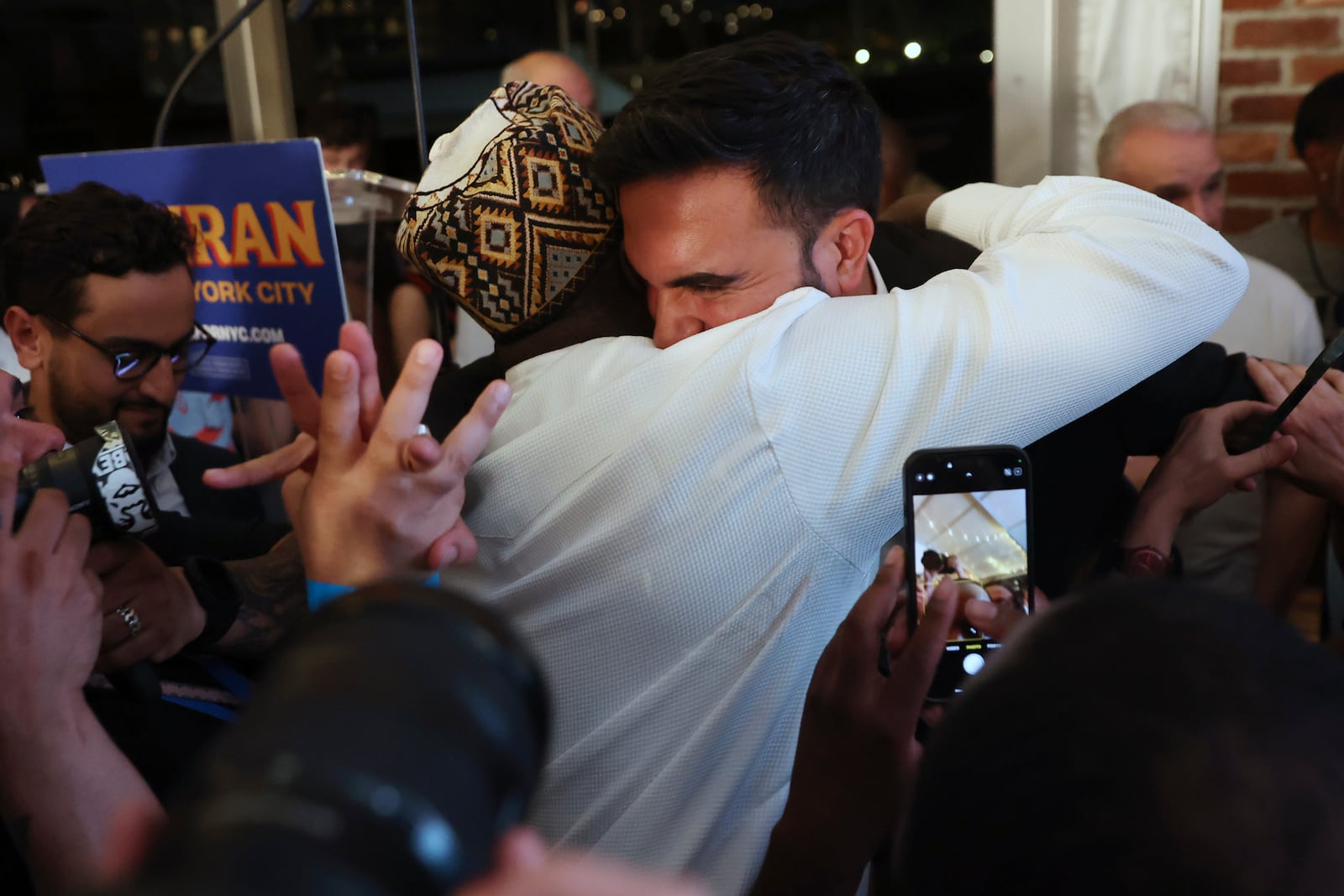 Democratic mayoral candidate Zohran Mamdani hugs supporters after speaking at his primary election party, Wednesday, June 25, 2025, in New York. (AP Photo/Heather Khalifa)