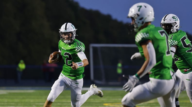 Badin quarterback Alex Ritzie looks for room to run vs. Fenwick during Friday night's game at Edgewood. Nick Graham/STAFF
