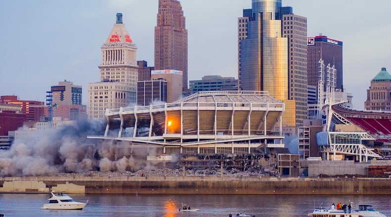 GREG LYNCH/JOURNALNEWS
(this is my best shot, please run)
A view from Newport near the mouth of the Licking River shows the implosion of Cinergy Field early Sunday morning.
