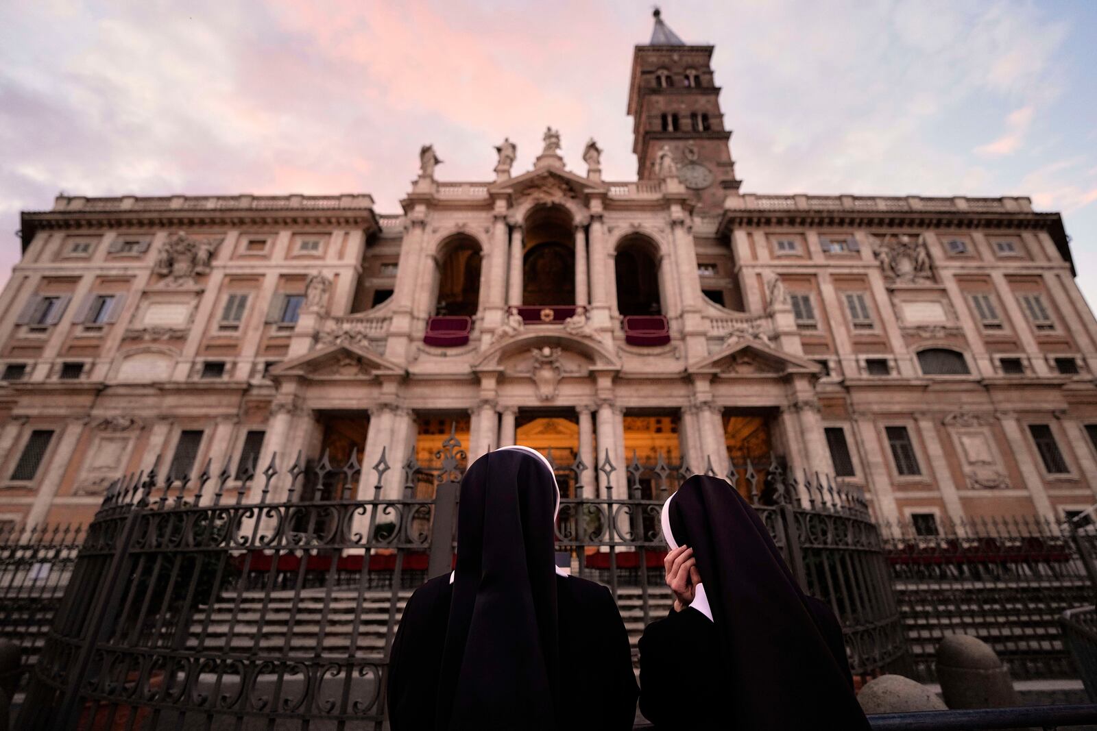 Nuns wait before a rosary prayer outside the Santa Maria Maggiore Basilica, where the late Pope Francis will be buried, in Rome, Thursday, April 24, 2025. (AP Photo/Andreea Alexandru)
