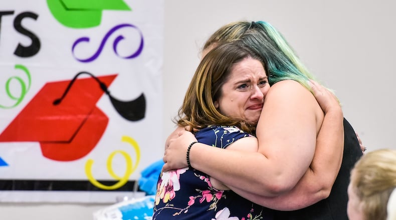 Case worker Amanda Hinkle, left, congratulates Corina Jean on her graduation during the Butler County Children Services graduation ceremony for kids involved in the foster care program Thursday, June 21 in Hamilton. Corina graduated from Belmont High School and plans to attend Sinclair Community College to be a pharmacy tech. NICK GRAHAM/STAFF
