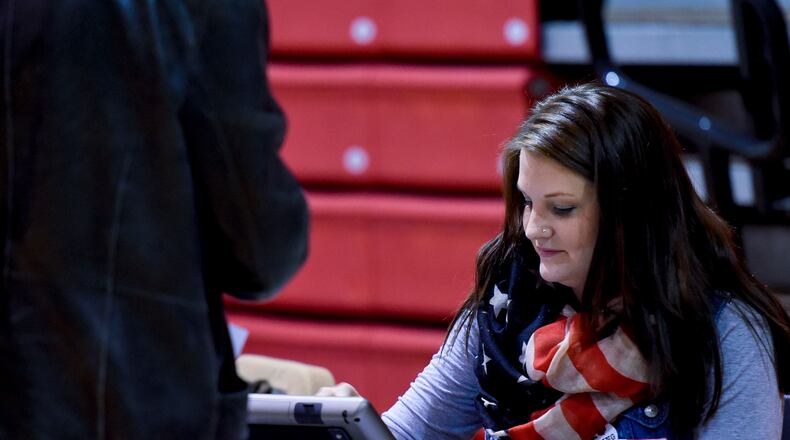 Poll worker Terrah Roberts verifies a voter’s address during a previous election in Butler County. Some 300 poll workers are needed in Butler County before November’s local-year election, according to the Butler County Board of Elections. NICK GRAHAM/STAFF