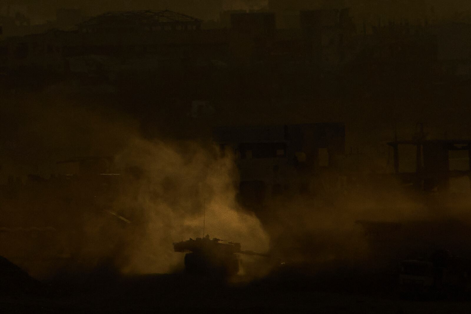 An Israeli army tank maneuvers in the Gaza Strip is seen from southern Israel, Sunday, May 4, 2025. (AP Photo/Ariel Schalit)