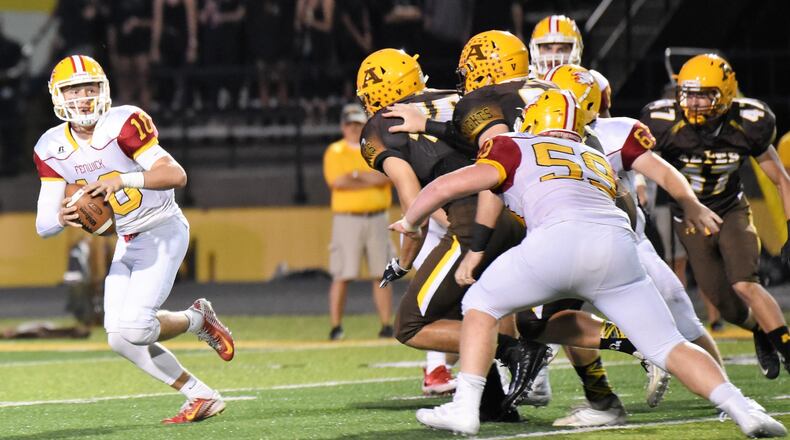 Fenwick quarterback Sully Janeck (10) is under pressure from the Alter defense last Friday night at Centerville Stadium. Janeck threw two touchdown passes, but the Falcons lost 45-20. CONTRIBUTED PHOTO BY ANGIE MOHRHAUS