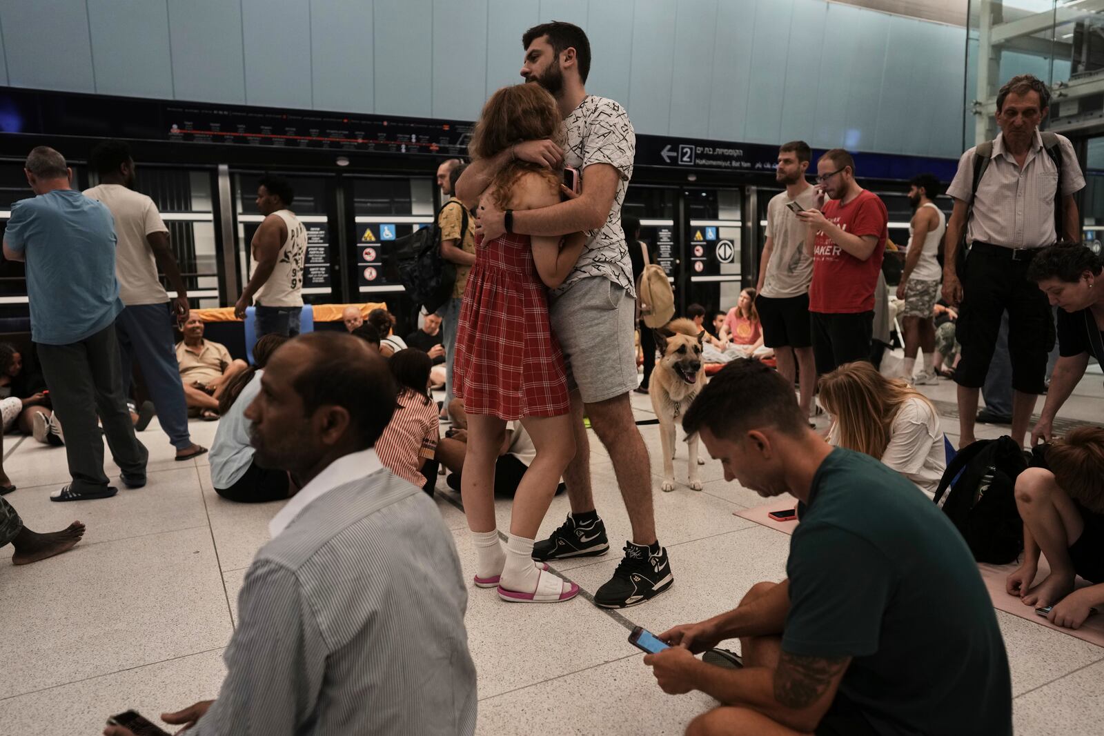 People shelter in an underground metro station as air raid sirens warn of incoming strikes by, in Ramat Gan, near Tel Aviv, Israel, Wednesday, June 18, 2025. (AP Photo/Oded Balilty)