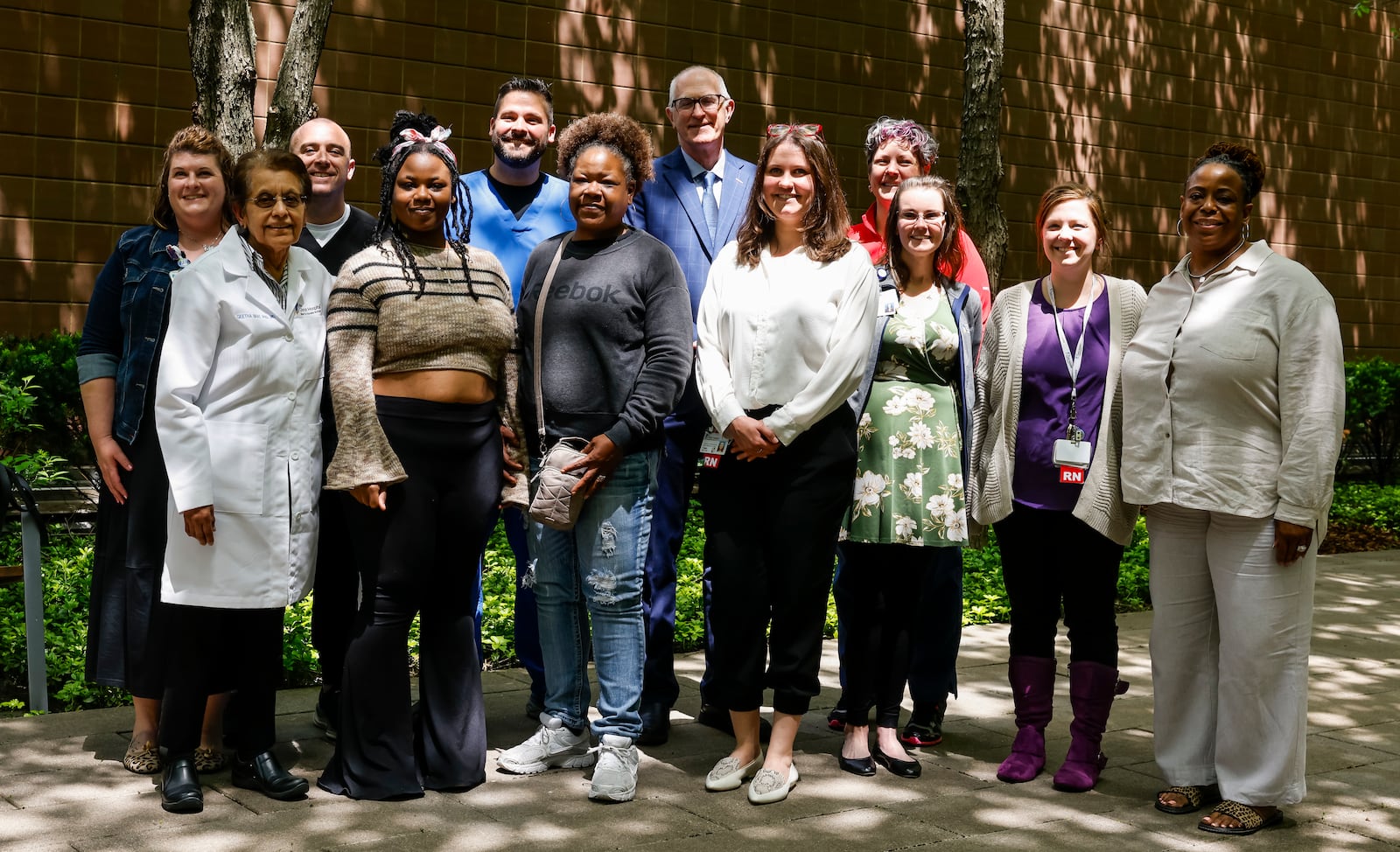 Shania Woods-Hicks, a 20-year-old from Dayton, stands with family an, doctors, nurses and more who were part of her journey to get a heart transplant at Christ Hospital in Cincinnati. NICK GRAHAM/STAFF
