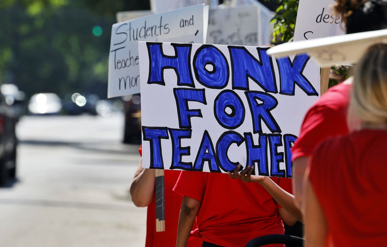 Hamilton teachers gathered along Dayton Street in front of the Hamilton City School District building to demonstrate for fair pay for teachers Wednesday, June 22, 2022. NICK GRAHAM/STAFF