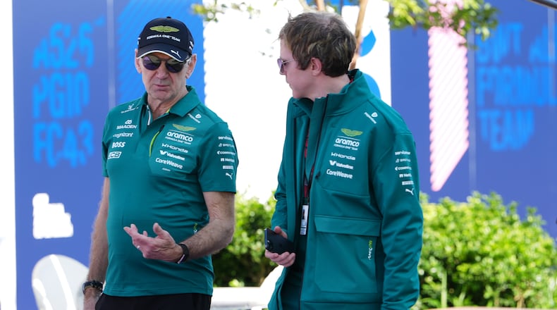 Aston Martin team principal Adrian Newey, left, talks with a team member as he arrives at the track ahead of the Australian Formula One Grand Prix at Albert Park, in Melbourne, Australia, Thursday, March 5, 2026. (AP Photo/Asanka Brendon Ratnayake)